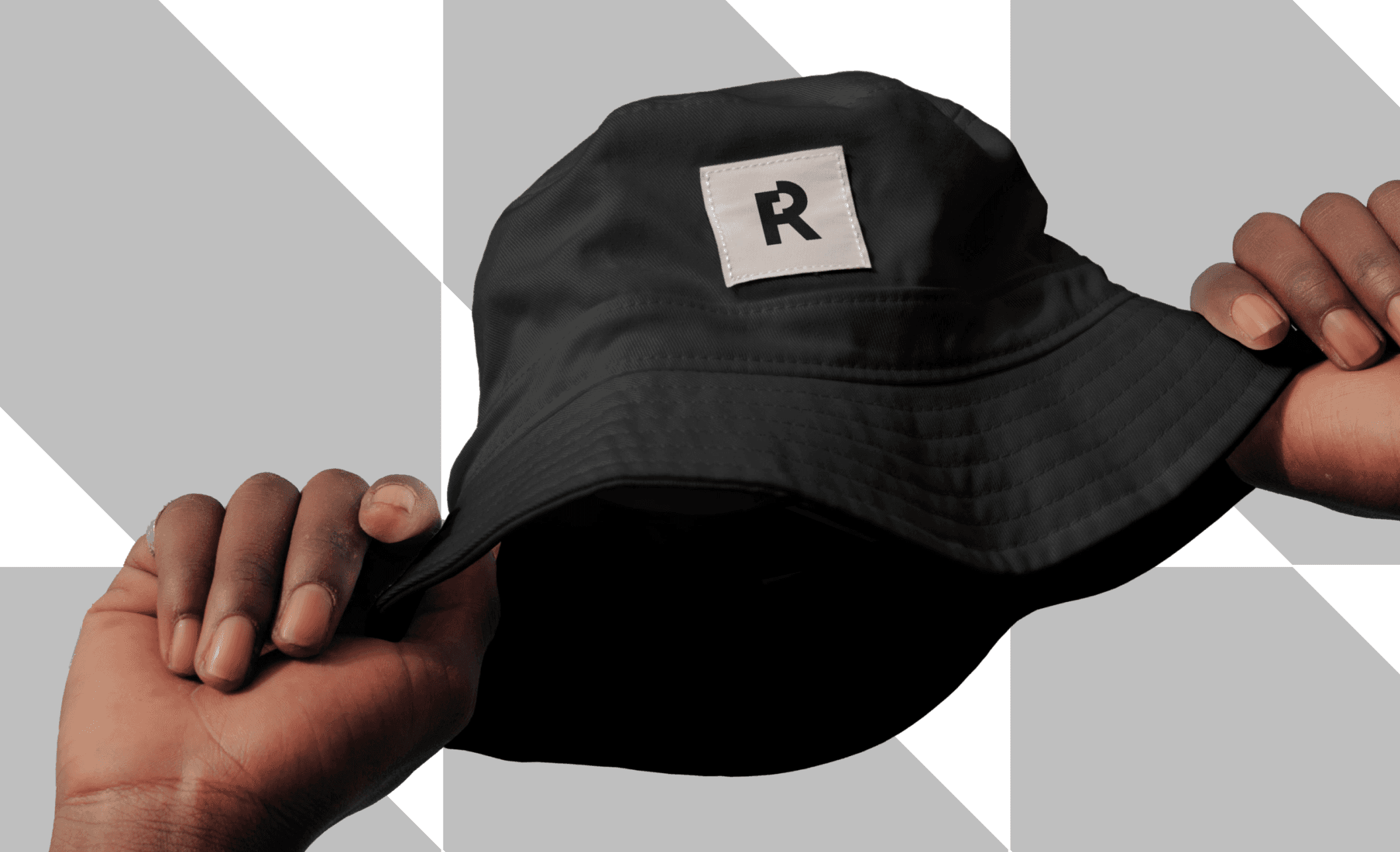 A bucket hat with Reaktor's logo on it