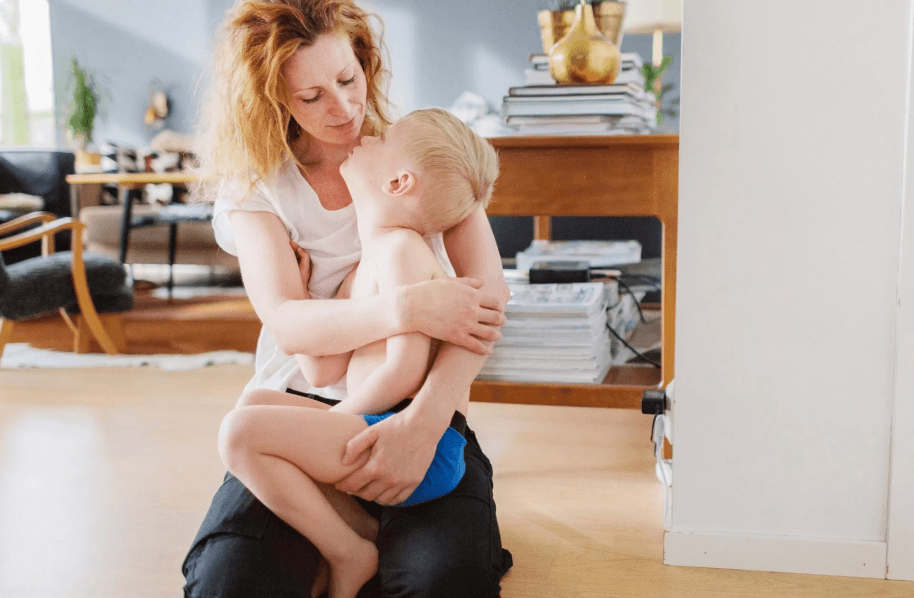 A person hold a child in their arms.