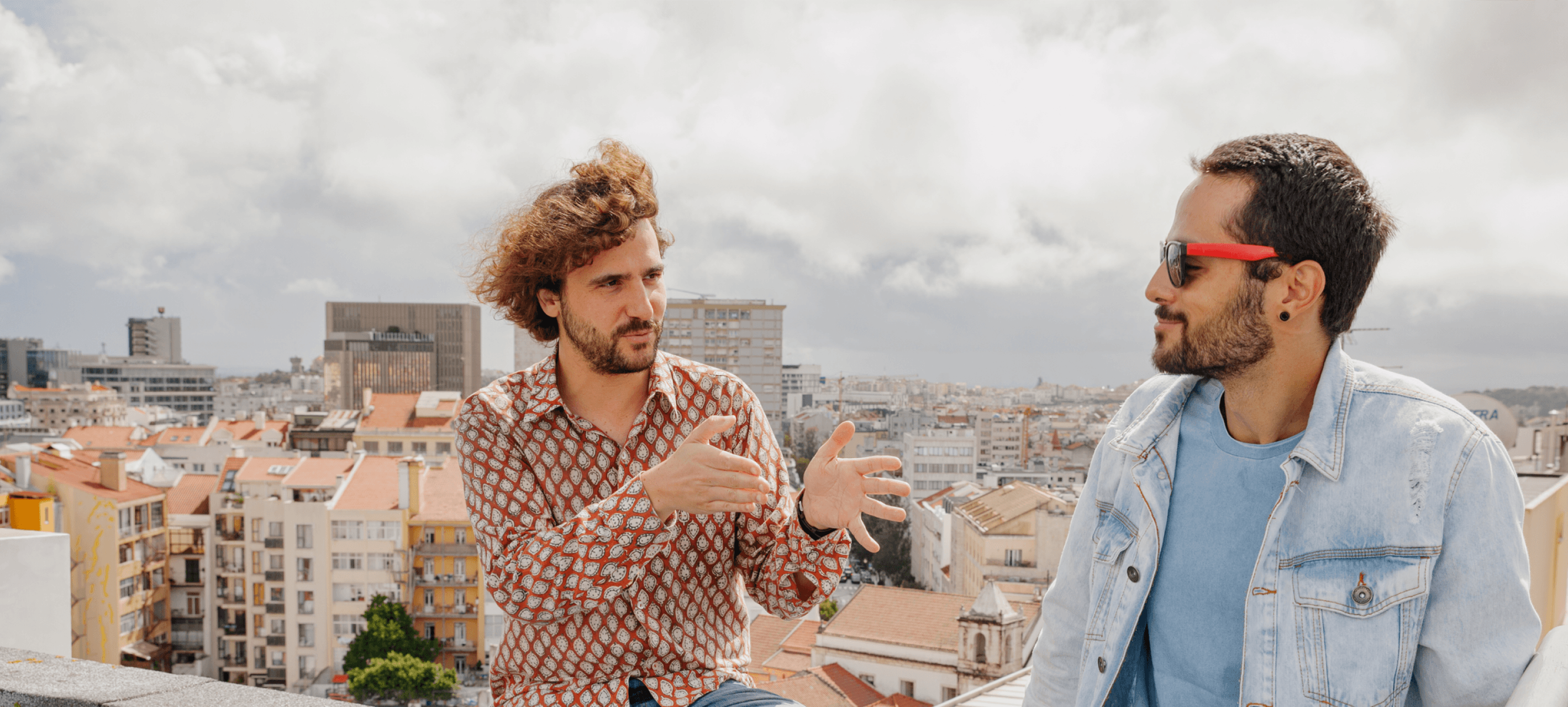 Two people talking on a NYC rooftop.